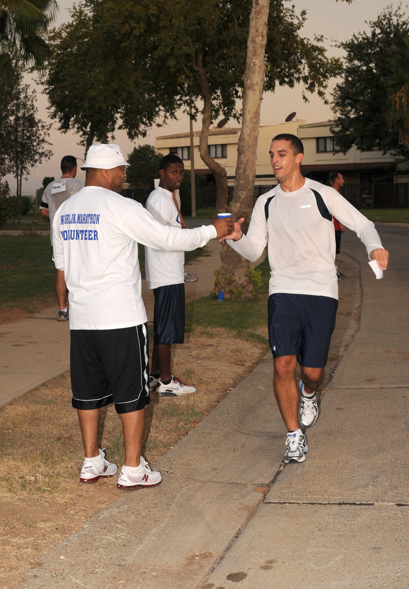 Senior Airman Kyle Gordon slows down for a drink during the Incirlik 1/2 Marathon Sept. 20. More than 70 members of Team Incirlik participated in the event. (U.S. Air Force photo by Senior Airman Heather Stanton)