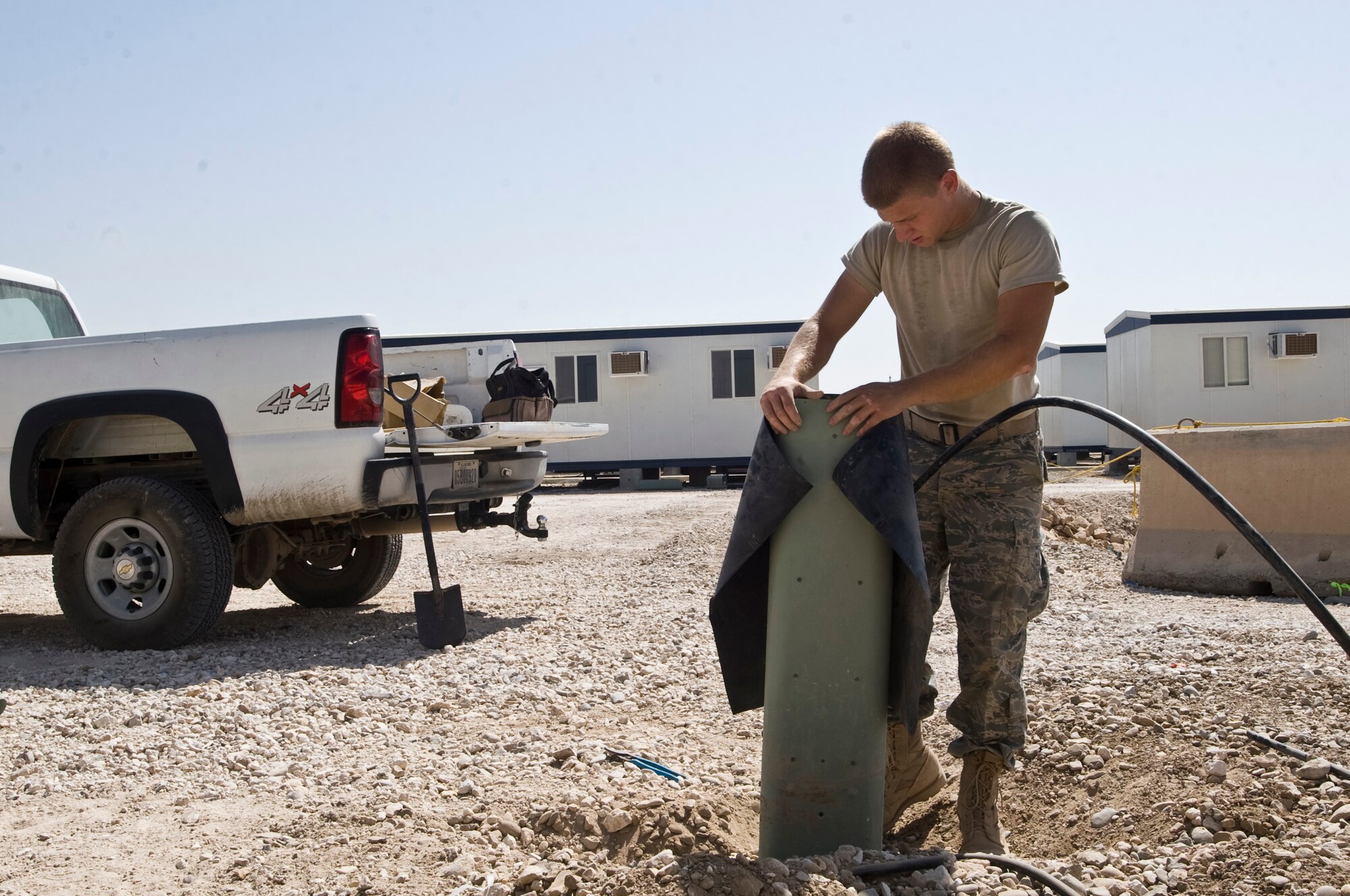 ALI BASE, Iraq -- Senior Airman George Carameta, 407th Expeditionary Communications Squadron network technician, installs the unit housing all telephone connections for the phase two trailer area Sept. 22, 2008. The 407th ECS "Wire Dogs" installed all the telephone connections for the phase two trailers that will soon house Airmen, currently living in tents, here.  Carameta is deployed from Tinker Air Force Base, Okla. (U.S. Air Force photo/Airman 1st Class Christopher Griffin)   