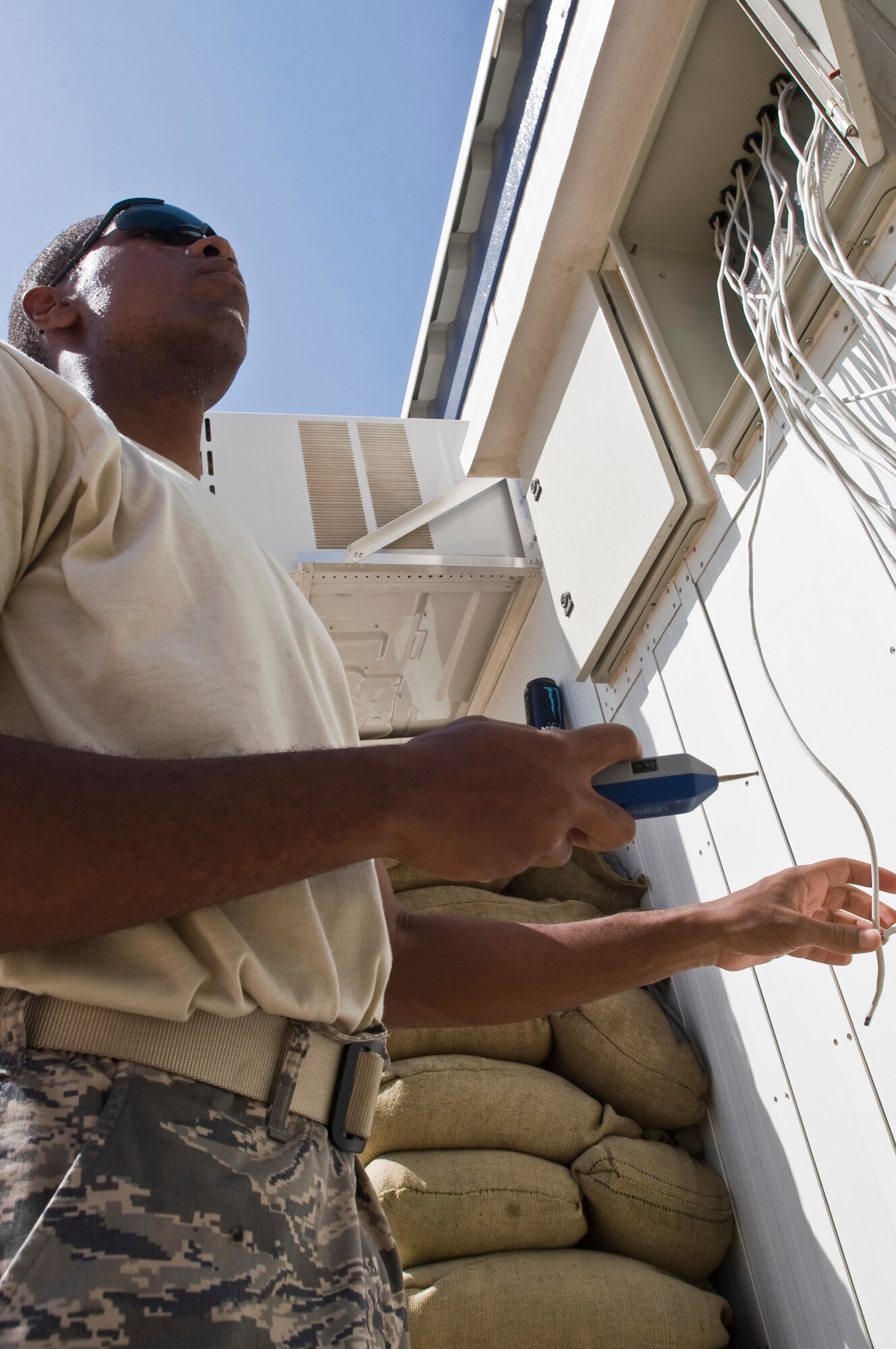 ALI BASE, Iraq -- Senior Airman William Page, 407th Expeditionary Communications Squadron network technician, searches for a telephone connection for the room he is connecting Sept. 22, 2008. The 407th ECS "Wire Dogs" installed all the telephone connections for the phase two trailers that will soon house Airmen, currently living in tents, here. Page is deployed from Tinker Air Force Base, Okla. (U.S. Air Force photo/Airman 1st Class Christopher Griffin)   