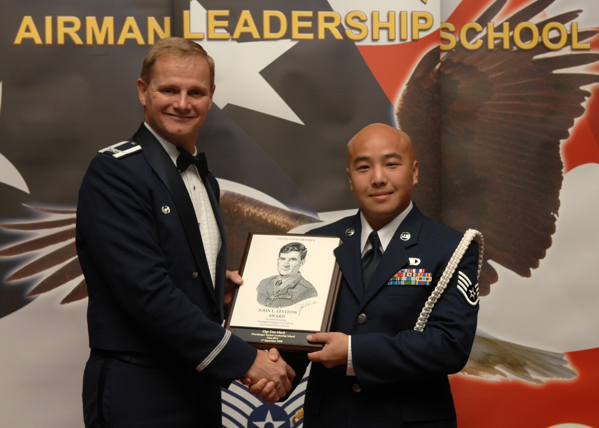 SPANGDAHLEM AIR BASE, Germany –- Staff Sgt. Dan Mach, 606 Air Control Squadron, receives the John L. Levitow Honor Graduate Award at the Airman Leadership School Graduation, class 08-6, Sept. 17, 2008. The Levitow Award is the highest honor awarded in the Professional Military Education. (U.S. Air Force photo by Airman Staci Miller)