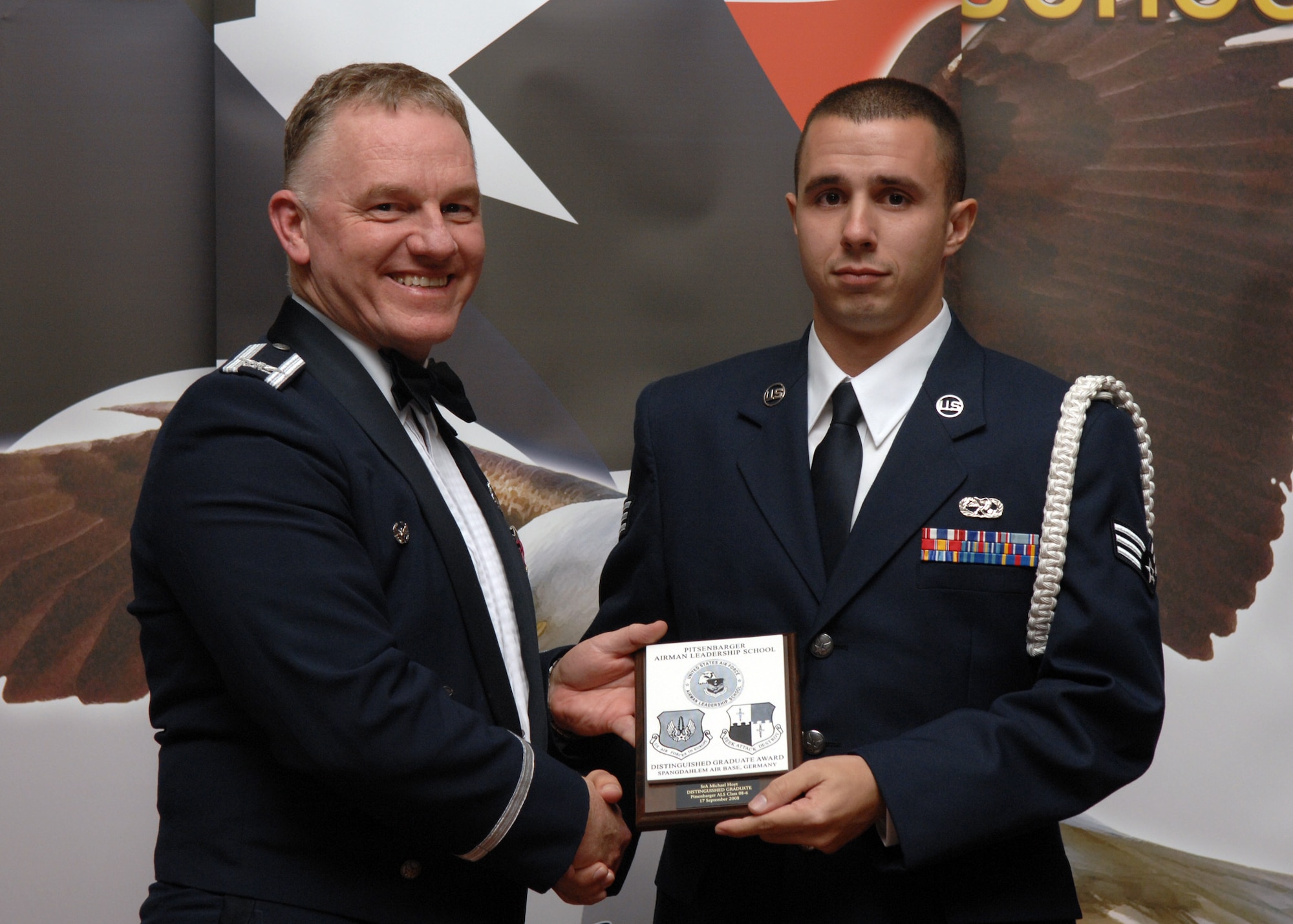 SPANGDAHLEM AIR BASE, Germany –- Senior Airman Michael Hoyt, 52nd Munitions Maintenance Group, receives a Distinguished Graduate Award at the Airman Leadership School Graduation, class 08-6, Sept. 17, 2008. (U.S. Air Force photo by Airman Staci Miller)