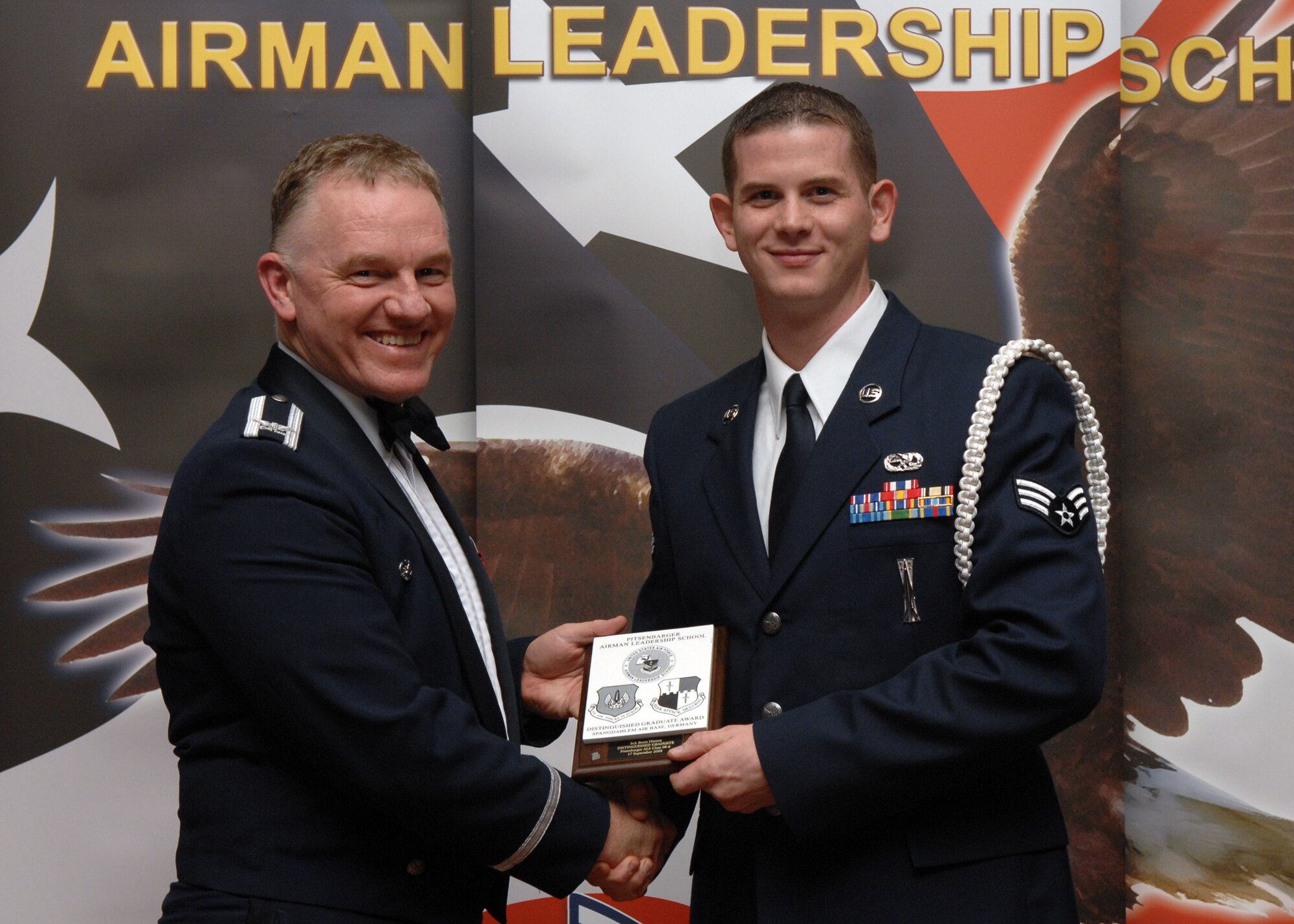 SPANGDAHLEM AIR BASE, Germany –- Senior Airman Brent Hinton, 52nd Equipment Maintenance Squadron, receives the Distinguished Graduate Award at the Airman Leadership School Graduation, class 08-6, Sept. 17, 2008. (U.S. Air Force photo by Airman Staci Miller)