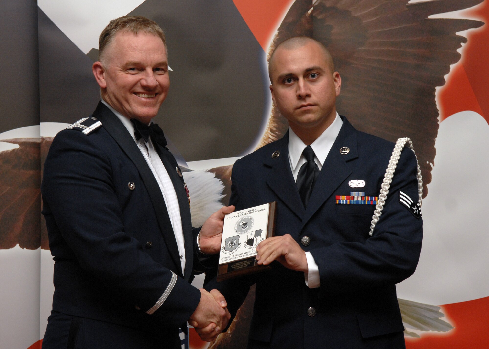 SPANGDAHLEM AIR BASE, Germany –- Senior Airman Jeremy Lewis, 52nd Civil Engineer Squadron, receives the Distinguished Graduate Award at the Airman Leadership School Graduation, class 08-6, Sept. 17, 2008. (U.S. Air Force photo by Airman Staci Miller)