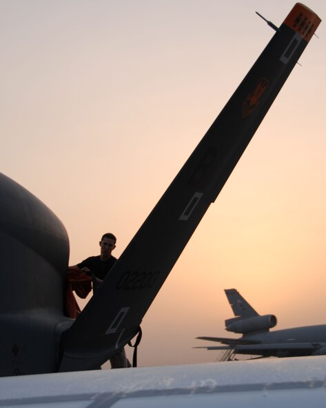 SOUTHWEST ASIA -- Staff Sgt. Craig Peterson, an avionics system technician with the 380th Expeditionary Aircraft Maintenance Squadron, attaches an exhaust cover to the first operational transatlantic joint-launched Global Hawk here Sept. 21. The unmanned aircraft just returned from its first sortie out of its new home at the 380th Air Expeditionary Wing here. It was only on the ground for about five hours after its historical flight Sept. 20 before being turned around and sent into the Area of Operations. Sergeant Peterson is deployed here from the 9th Aircraft Maintenance Squadron's 12th Aircraft Maintenance Unit out of Beale Air Force Base, Calif. He hails from North Bend, Ore. (U.S. Air Force photo/Tech. Sgt. Denise Johnson)(released)