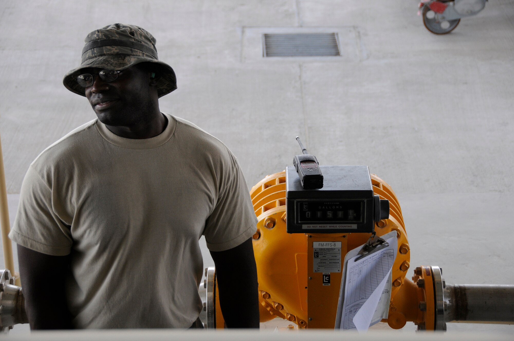 Staff Sgt. Sean Fishburne, 379th Expeditionary Logistics Readiness Squadron, tests the high-level sensor in a fuel truck by verifying exactly 1511 gallons of fuel was pumped into the tank when the sensor stopped fuel pumping Sept. 22, 2008.  The truck has been reported as having a problem with the sensor that cuts off the flow of fuel as it reaches a maximum height within the fuel tank at this undisclosed air base in Southwest Asia.  To check the sensor a set amount of fuel is pumped out of the truck, and then the automatic system pumps fuel in until the fuel reaches the sensor and automatically shuts off the flow of fuel into the tank.  If the amount of fuel pumped out equals the amount pumped in before sensor shut off, the sensor is working properly.  Sergeant Fishburne, a native of Charleston, S.C., is deployed from Dover Air Force Base, Del., in support of Operations Iraqi and Enduring Freedom and Joint Task Force-Horn of Africa.  (U.S. Air Force photo by Tech. Sgt. Michael Boquette/Released)