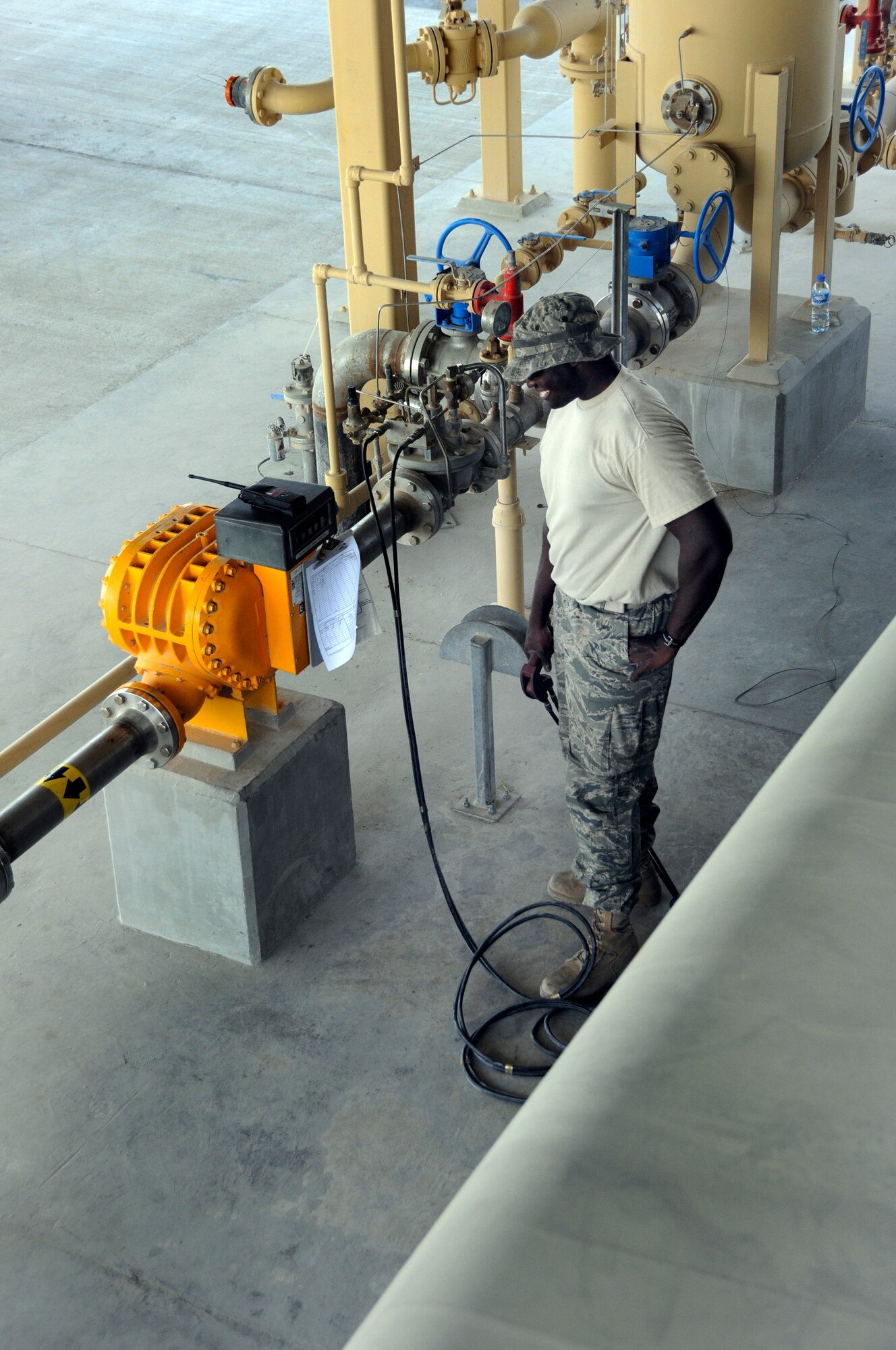 Staff Sgt. Sean Fishburne, 379th Expeditionary Logistics Readiness Squadron, watches the meter while holding the kill switch during testing of the high-level sensor in a fuel truck Sept. 22, 2008.  The truck has been reported as having a problem with the sensor that cuts off the flow of fuel as it reaches a maximum height within the fuel tank at this undisclosed air base in Southwest Asia.  To check the sensor a set amount of fuel is pumped out of the truck, and then the automatic system pumps fuel in until the fuel reaches the sensor and automatically shuts off the flow of fuel into the tank.  If the amount of fuel pumped out equals the amount pumped in before sensor shut off, the sensor is working properly.  Sergeant Fishburne, a native of Charleston, S.C., is deployed from Dover Air Force Base, Del., in support of Operations Iraqi and Enduring Freedom and Joint Task Force-Horn of Africa.  (U.S. Air Force photo by Tech. Sgt. Michael Boquette/Released)