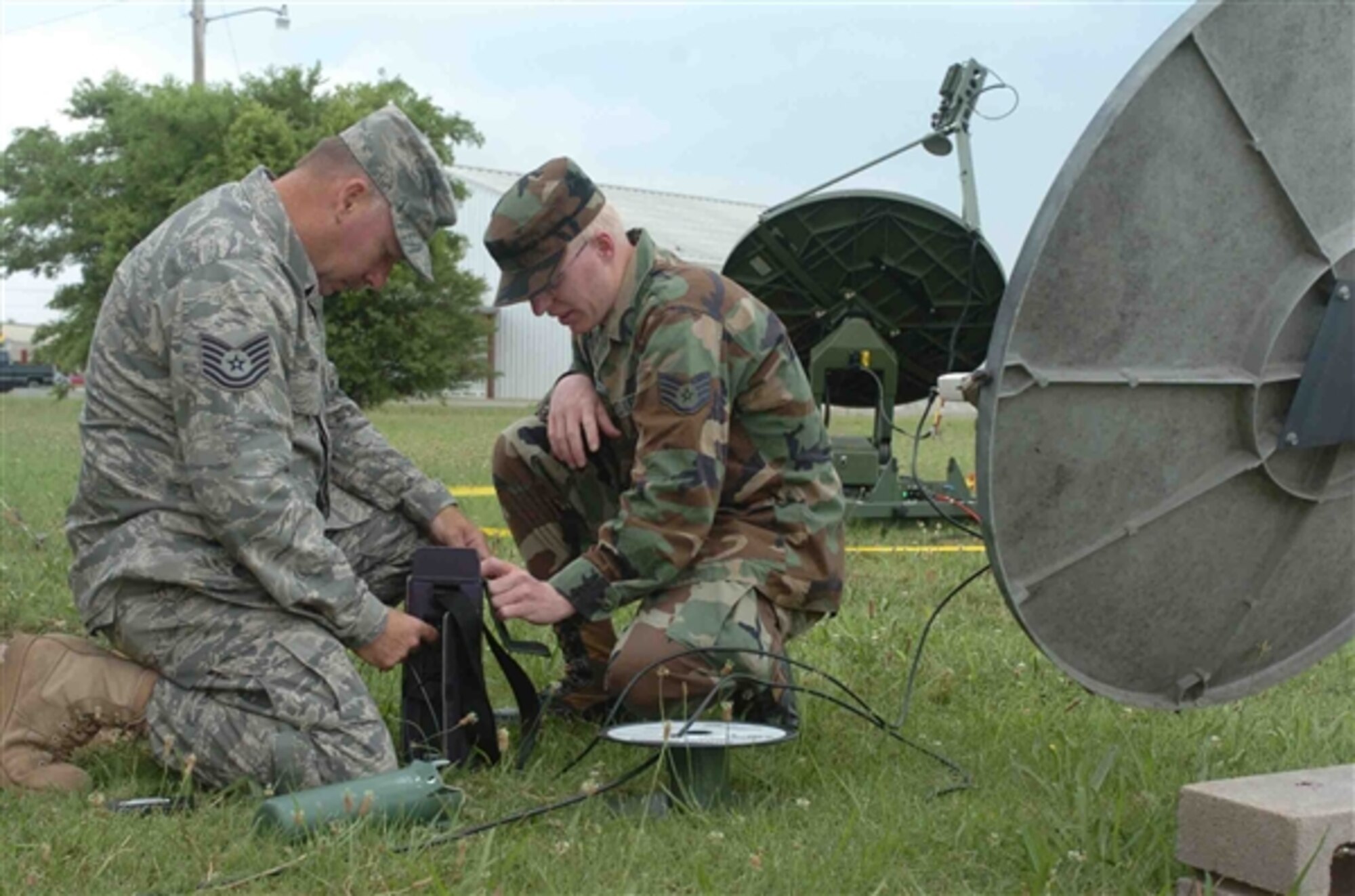 Air Force Tech. Sgt. Bill Smith (left) practices aligning a satellite with the help of Air Force Staff Sgt. Scott Roach. They are members of the Arkansas Air Guard's 154th Weather Flight, which provided weather support to the Arkansas Army National Guard's 1st Battalion, 114th Security and Support, during recent annual training. National Guard members from various states are preparing for Tropical Storm Gustav, expected to make landfall on the U.S. Gulf Coast as a Category 3 hurricane on Sept. 2, 2008. (U.S. Army photo by 2nd Lt. Theresa L. Walker)