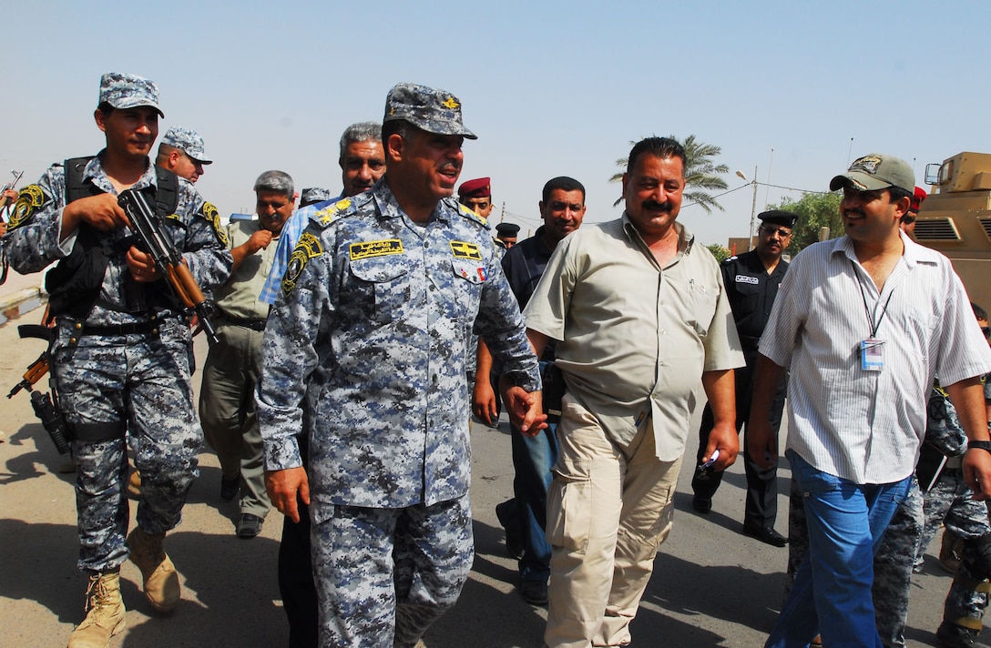 Iraqi National Police Brig. Gen. Karim, commander of the 7th Brigade, 2nd National Police Division, tours ongoing resettlement efforts Sept. 18, 2008, with “Sons of Iraq” citizen security group supervisor Ayad Rashed in the Hadar community of southern Baghdad’s Rashid district. Iraqi commanders are using Iraqi media, community leaders and word of mouth to ask displaced families to return to their homes. U.S. Army photo by Staff Sgt. Brent Williams, Multinational Division Baghdad