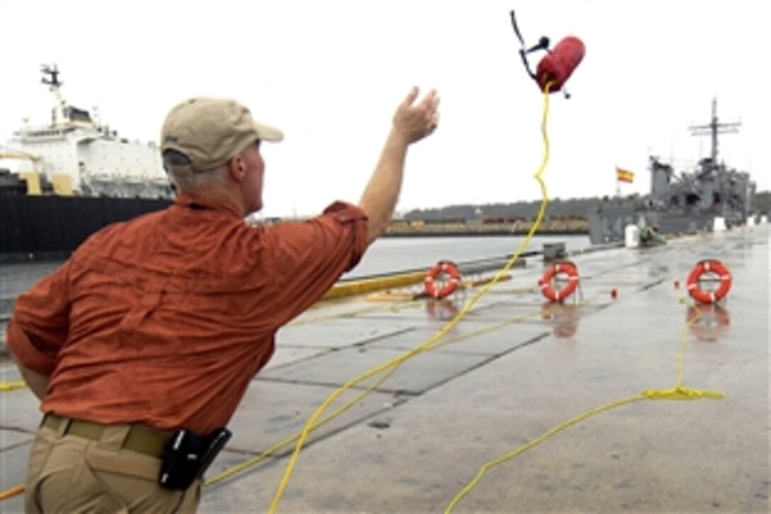 Chris Van Gorder, CEO, Scripps Health, tries his luck at throwing a U.S. Coast Guard rescue line while touring the Coast Guard Cutter Dallas on Naval Air Station Rota, Spain, Sept. 22, 2008.  Gorder is a participant of the 76th Joint Civilian Orientation Conference, which teaches civilian leaders about Defense Department activities.