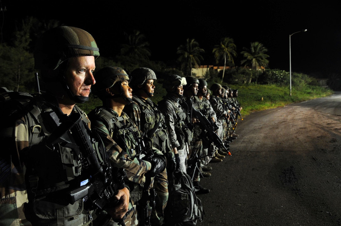 ANDERSEN AIR FORCE BASE, Guam - Members from the 154th Security Forces Squadron, Hawaii Air National Guard, stand ready for an upcoming scenario at Commando Warrior here Sept. 19. Approximately 1,500 students attend these courses annually to meet PACAF's training and deployment requirements. (U.S. Air Force photo by Airman 1st Class Courtney Witt)
