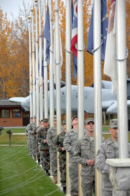 Volunteers lower the state flags Sept. 19, 2008 during the POW/MIA ceremony at Heritage Park on Eielson Air Force Base. The POW/MIA ceremony takes place to recognize the prisoners of war and military members labeled missing in action in past wars. (U.S. Air Force photo by Airman 1st Class Willard E. Grande II)