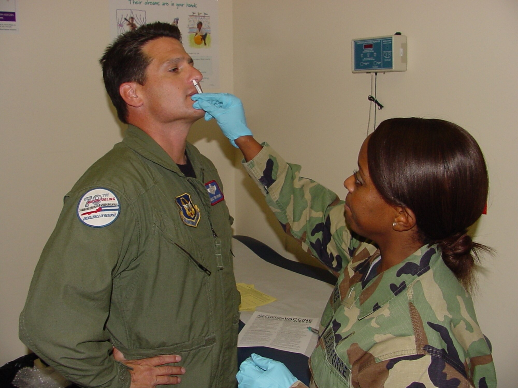Chief Master Sgt. Terry Monges from the 79th Aerial Refueling Squadron receives a flu vaccine by mist inhalant from Staff Sgt. Dorcas Stokes, 60th Medical Operations Squadron Allergy/Immunization Clinic technician at the David Grant USAF Medical Center. The influenza vaccine is a mandatory DOD requirement for all military personnel. The flu vaccine will be given out Sept. 30 through Oct.3 from 9 a.m. to 3 p.m. for Active Duty at the Chapel One Annex, Nov. 12 through 14 from 9 a.m. to 3 p.m. for Active Duty and family members and every Wednesday beginning Oct. 15 at the Pediatric Clinic from 4 to 6 p.m. for families with children. (U.S. Air Force photo/Jim Spellman)