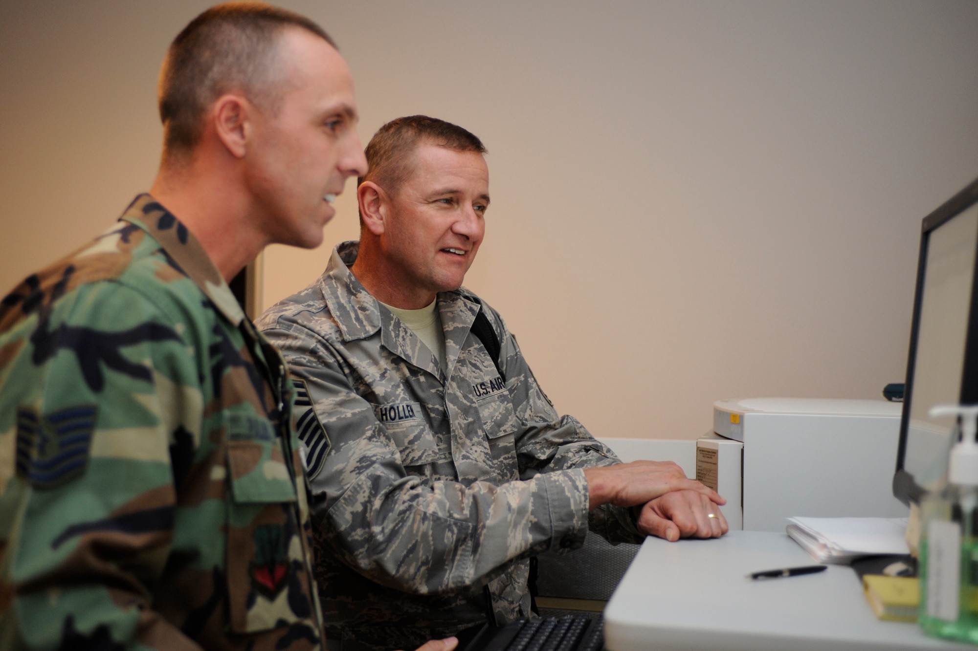 (left)Tech. Sgt. Keith Pullins, 28th Medical Support Squadron NCO in charge of teleradiology, shows Chief Master Sgt. Lloyd Hollens, 12th Air Force command chief, various x-rays during his tour of the 28th Medical Group clinic Sept. 23. During his tour, Chief Hollen received briefs on various medical career fields. (U.S. Air Force photo/Airman Matthew Flynn)
