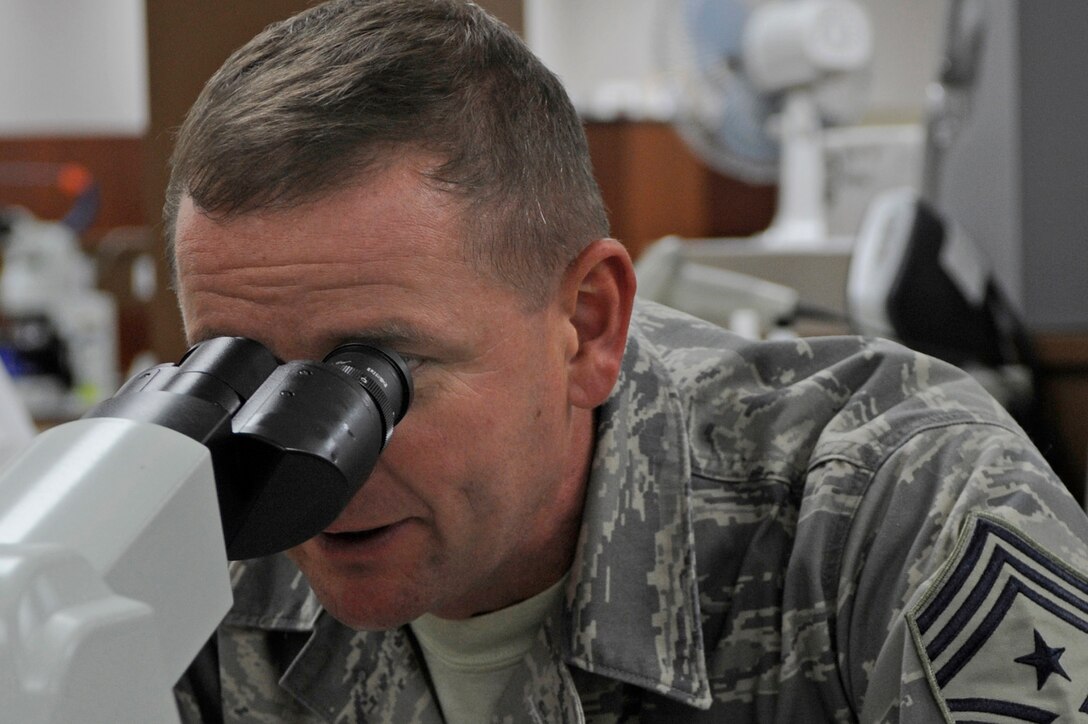 Chief Master Sgt. Lloyd Hollen, 12th Air Force command chief, reviews results of his blood test with Staff Sgt. Jody Haslip, 28th Medical Support Squadron lab technician here Sept. 23. Chief Hollen toured the 28th Medical Group clinic and talked with Airmen about their career fields and current events throughout the Air Force. (U.S. Air Force photo/Airman Matthew Flynn)