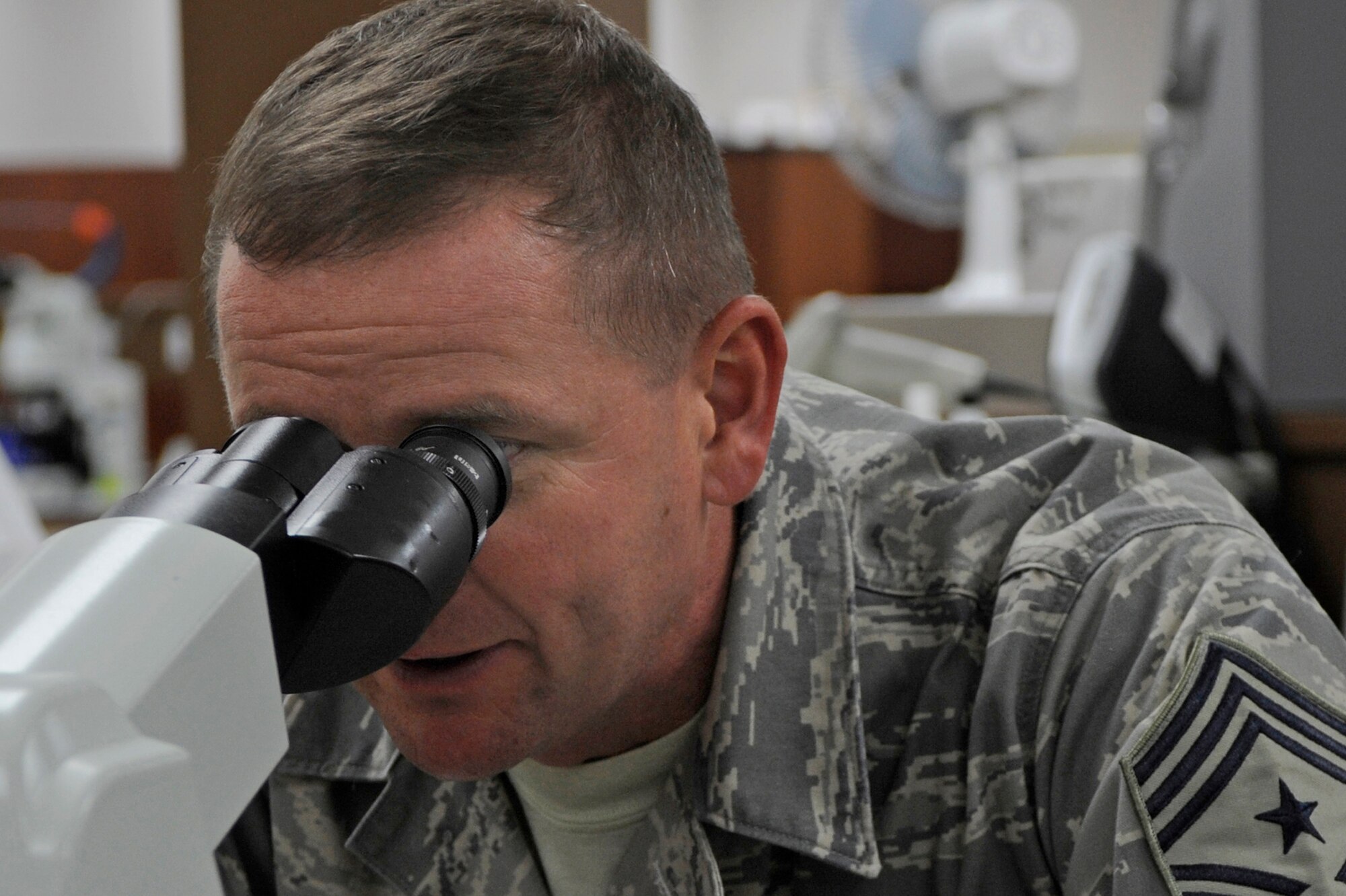 Chief Master Sgt. Lloyd Hollen, 12th Air Force command chief, reviews results of his blood test with Staff Sgt. Jody Haslip, 28th Medical Support Squadron lab technician here Sept. 23. Chief Hollen toured the 28th Medical Group clinic and talked with Airmen about their career fields and current events throughout the Air Force. (U.S. Air Force photo/Airman Matthew Flynn)