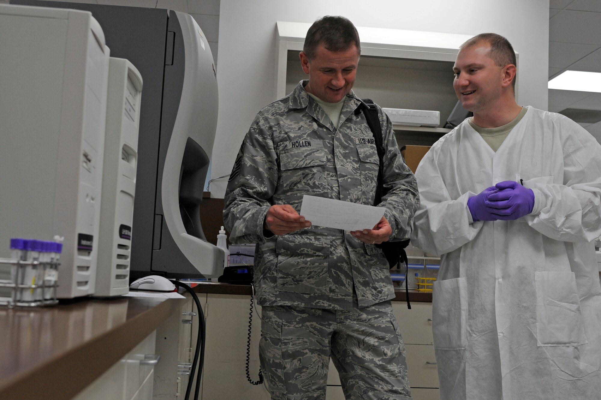 Chief Master Sgt. Lloyd Hollen, 12th Air Force command chief, reviews results of his blood test with Staff Sgt. Jody Haslip, 28th Medical Support Squadron lab technician here Sept. 23. Chief Hollen toured the 28th Medical Group clinic and talked with Airmen about their career fields and current events throughout the Air Force. (U.S. Air Force photo/Airman Matthew Flynn)