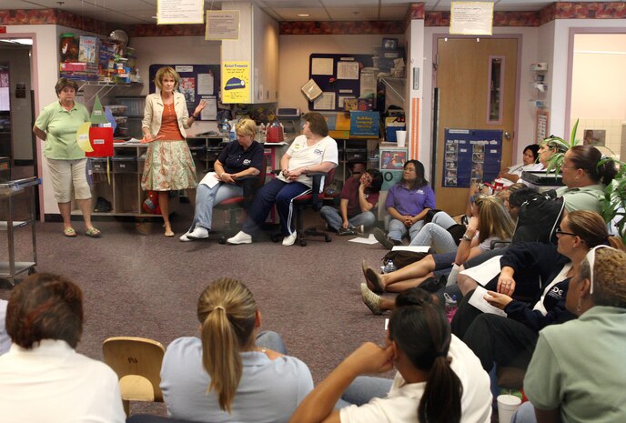 NELLIS AIR FORCE BASE, Nev. -- Joan Rowe, speech therapist, and Rosie Merback, special education teacher (left to right), both from the College of Southern Nevada, brief day care providers on "Language and Literacy" for preschool students. The Child Development Centers on base closed for a quarterly training day, allowing staff members to refresh their skills and receive required training..(U.S. Air Force Photo by Lawrence R. Crespo)