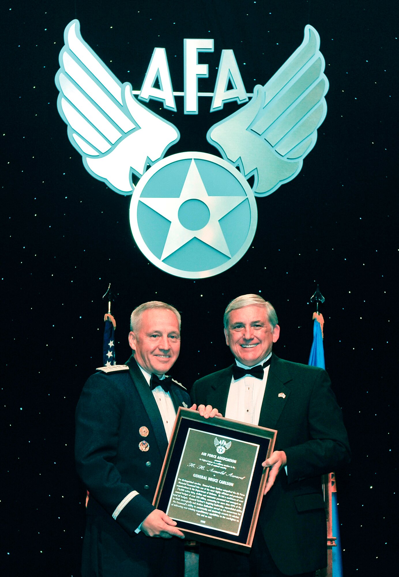 Gen. Bruce Carlson receives the H. H. Arnold award from Air Force Association chairman Robert Largent Sept. 17 at the Marriott Wardman Park Hotel in Washington, D.C. AFA hosted its 24th annual Air & Space Conference and Technology Exposition Sept. 15-17. General Carlson is the commander of Air Force Materiel Command. (U.S. Air Force photo/Michael Pausic)