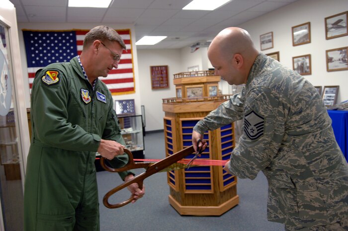 Brig. Gen. Stephen Hoog and Master Sgt. Robert Brooks cut the ribbon at the Air Force Heritage room in the Airmen's Leadership School, Nellis Air Force Base, Nev., Sept. 17, 2008. The ribbon cutting ceremony was an event that celebrates the opening of the Air Force Heritage room. The week put a spot light on Air Force tradition, heritage, and success.  (U.S. Air Force Photo by Airman 1st Class Brett Clashman)