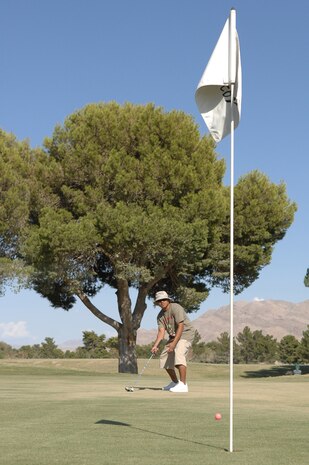 Staff Sgt. Manny Lazo, a Force Management team memberwith the 99th Mission Support Squadron at Nellis Air Force Base, NV.,  attempts a putt during the Boss and Buddy golf tournament held at the Nellis Sunrise Vista Golf Course on Sept. 18, 2008.  The Boss and Buddy golf tournament was held in conjunction with Air Force Heritage Week celebrated during the week of the United States Air Force's birthday.  (U.S. Air Force photo/Senior Airman Brian Ybarbo)