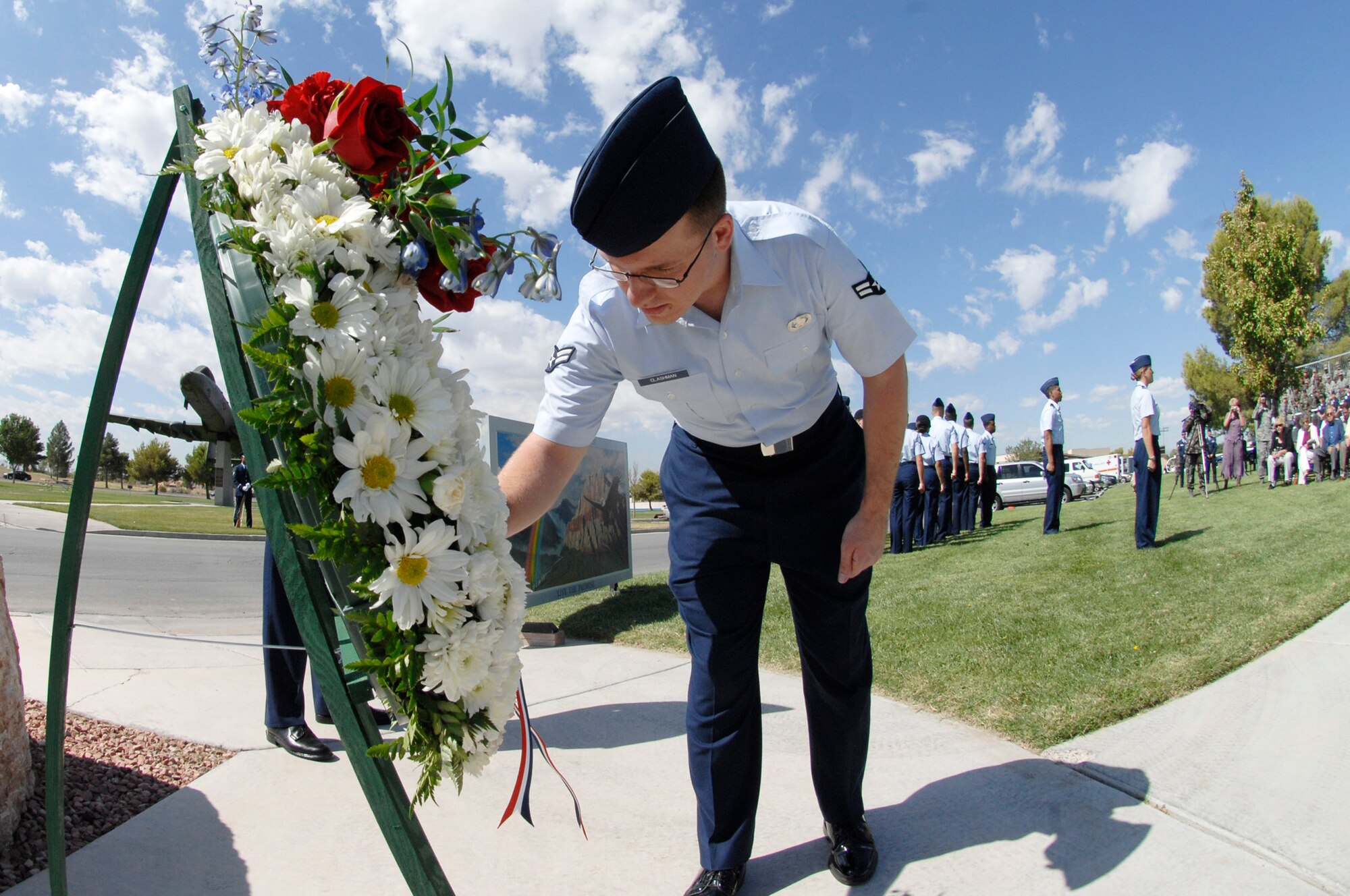 Airman 1st Class Brett Clashman, 99th Air Base Wing, Public Affairs, places a flower upon a wreath in remembrance of prisoners of war and those missing in action during the POW / MIA Ceremony, Nellis Air Force Base Nev., September 19, 2008. The ceremony is held annually for Surviving Veterans and those that never returned from combat. This year the ceremony took place during the Air Force Heritage week, which celebrated the Air Force?s 61st birthday and put a spot light on Air Force tradition, heritage, and success.  

(U.S. Air Force Photo by Airman 1st Class Stephanie Rubi)
