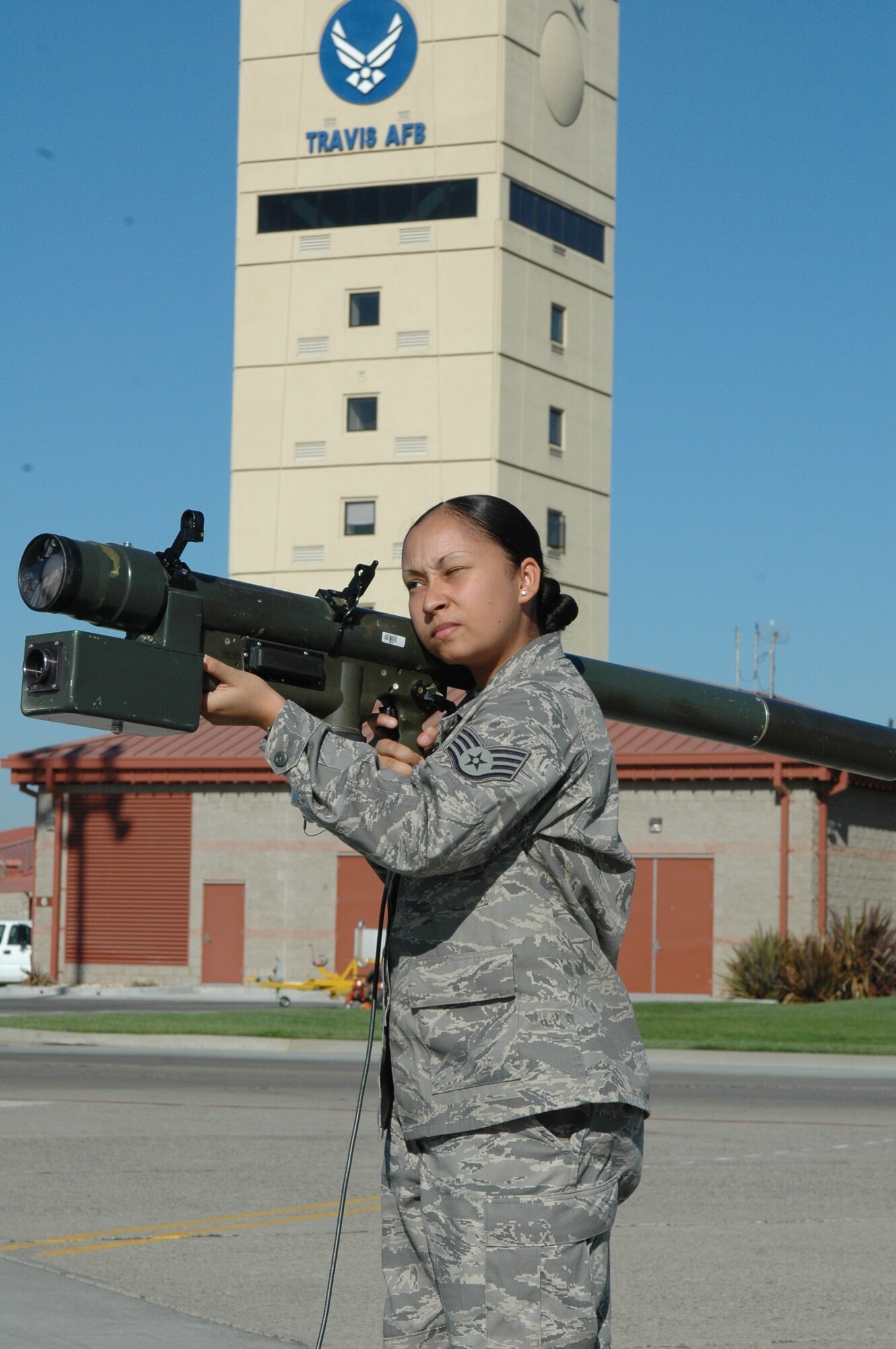 Staff Sgt. Tiffany Scott, 60th Operations Support Squadron combat weather forecaster, simulates using a Man Portable Air Defense System on the flightline Sept. 24. The simulation allowed Travis members a chance to learn first-hand about some of the most dangerous and prevalent threats to mobility aircraft around the world and gain a better understanding of these threats in accomplishing their mission. (U.S. Air Force photo/Tech. Sgt. Donald Osborn)  