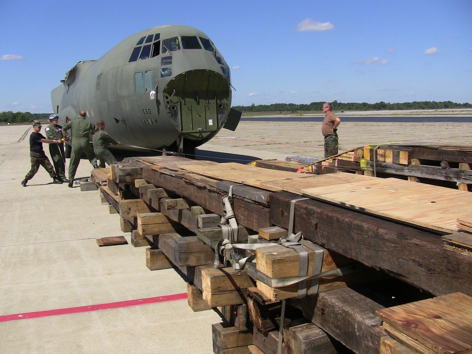 QUONSET POINT, R.I. -- Guardsmen load a C-130 training fuselage onto a C-5 for transport to Stratton Air National Guard Base, N.Y., using a shoring kit that they built. It took about three weeks to build the shoring kit and a lot of planning. The kit weighs about 22,000 pounds.