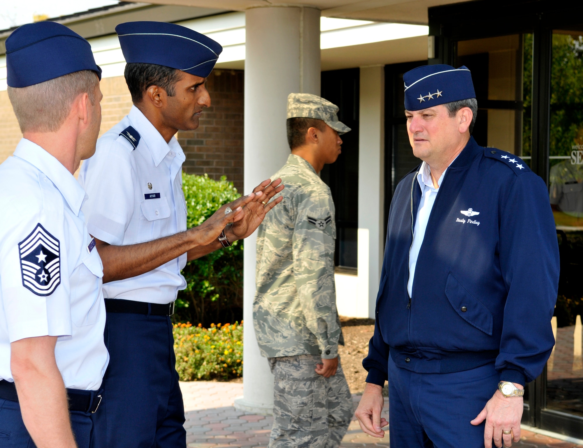 Col. Balan Ayyar, 305th Air Mobility Wing commander, briefs Lt. Gen. Rusty Findley, Air Mobility Command vice commander, on changes going on at McGuire outside the dining facility Sept. 22. General Findley had lunch with McGuire Airmen during his visit and stopped by the U.S. Air Force Expeditionary Center at Fort Dix. (U.S. Air Force photo/Kenn Mann)