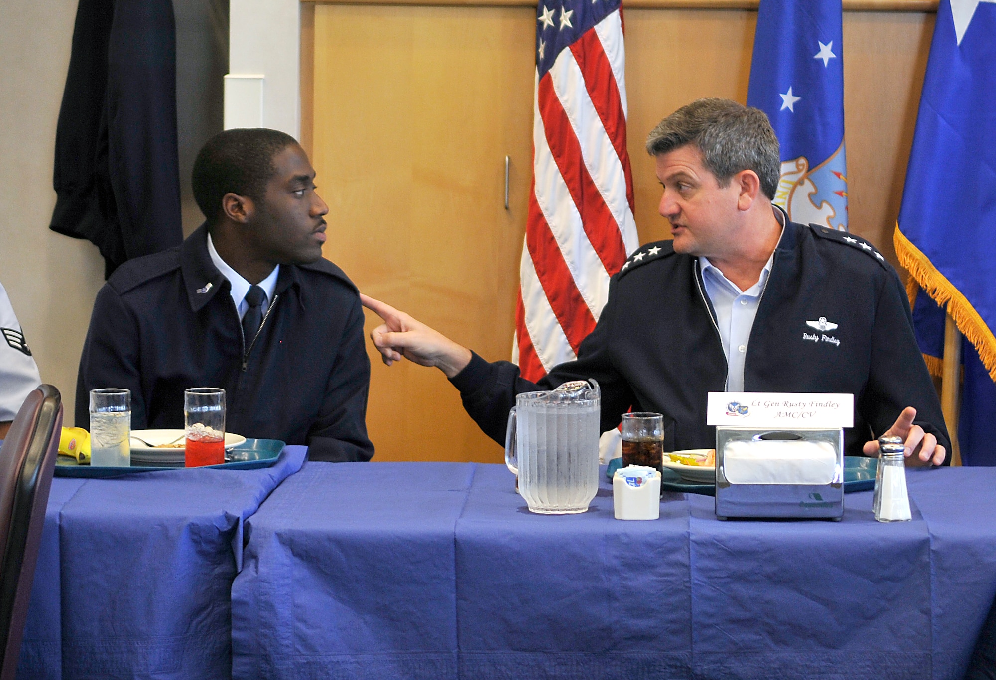 Airman 1st Class Rodricuz Williams, 305th Operations Support Squadron airfield management flight, gets a response to his question from Lt. Gen. Rusty Findley, Air Mobility Command vice commander Sept. 22. General Findley had lunch with Airmen at McGuire’s Dining Facility during part of his visit to McGuire. (U.S. Air Force photo/Kenn Mann)