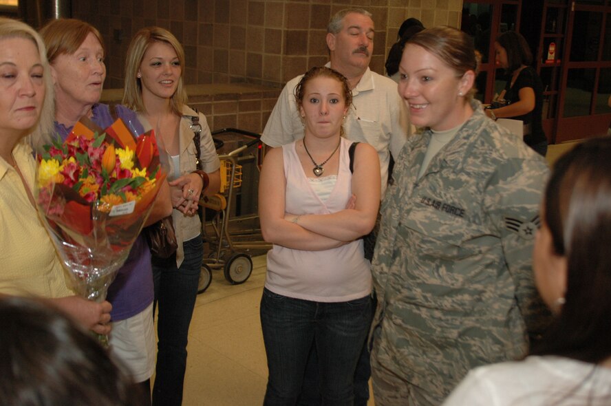After six months in Afghanistan, member of the 433rd Civil Engineer Squadron returned home on Sept 22, 2008. Family and friends met them at San Antonio Airport with banners, cheers and even a few happy tears were shed during the reunion. The Alamo Wing engineers spent their deployment building and repairing structures at Bagram Airfield and several forward operating locations. They installed air conditioning units for Soldiers, brought older buildings up to U.S. Military construction codes and built brand new facilities. The group joined up with members of the Niagara Falls Air Force Reserve unit to create the first Prime BEEF, or Prime Base Emergency Engineer Force, team to operate in the country in almost two years.  (U.S. Air Force Photo/Master Sgt. Daniel Nathaniel)
