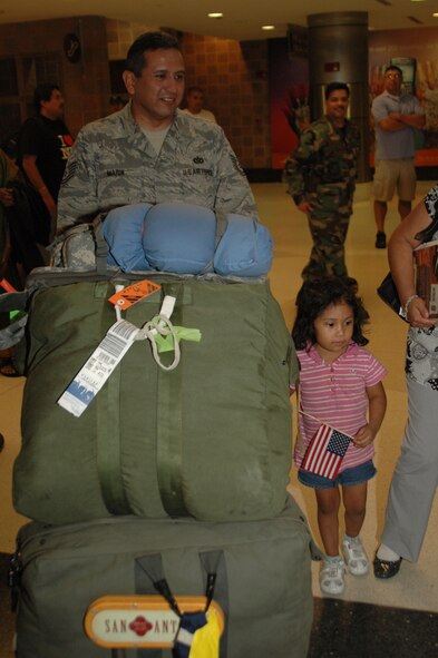After six months in Afghanistan, member of the 433rd Civil Engineer Squadron returned home on Sept 22, 2008. Family and friends met them at San Antonio Airport with banners, cheers and even a few happy tears were shed during the reunion. The Alamo Wing engineers spent their deployment building and repairing structures at Bagram Airfield and several forward operating locations. They installed air conditioning units for Soldiers, brought older buildings up to U.S. Military construction codes and built brand new facilities. The group joined up with members of the Niagara Falls Air Force Reserve unit to create the first Prime BEEF, or Prime Base Emergency Engineer Force, team to operate in the country in almost two years.  (U.S. Air Force Photo/Master Sgt. Daniel Nathaniel)
