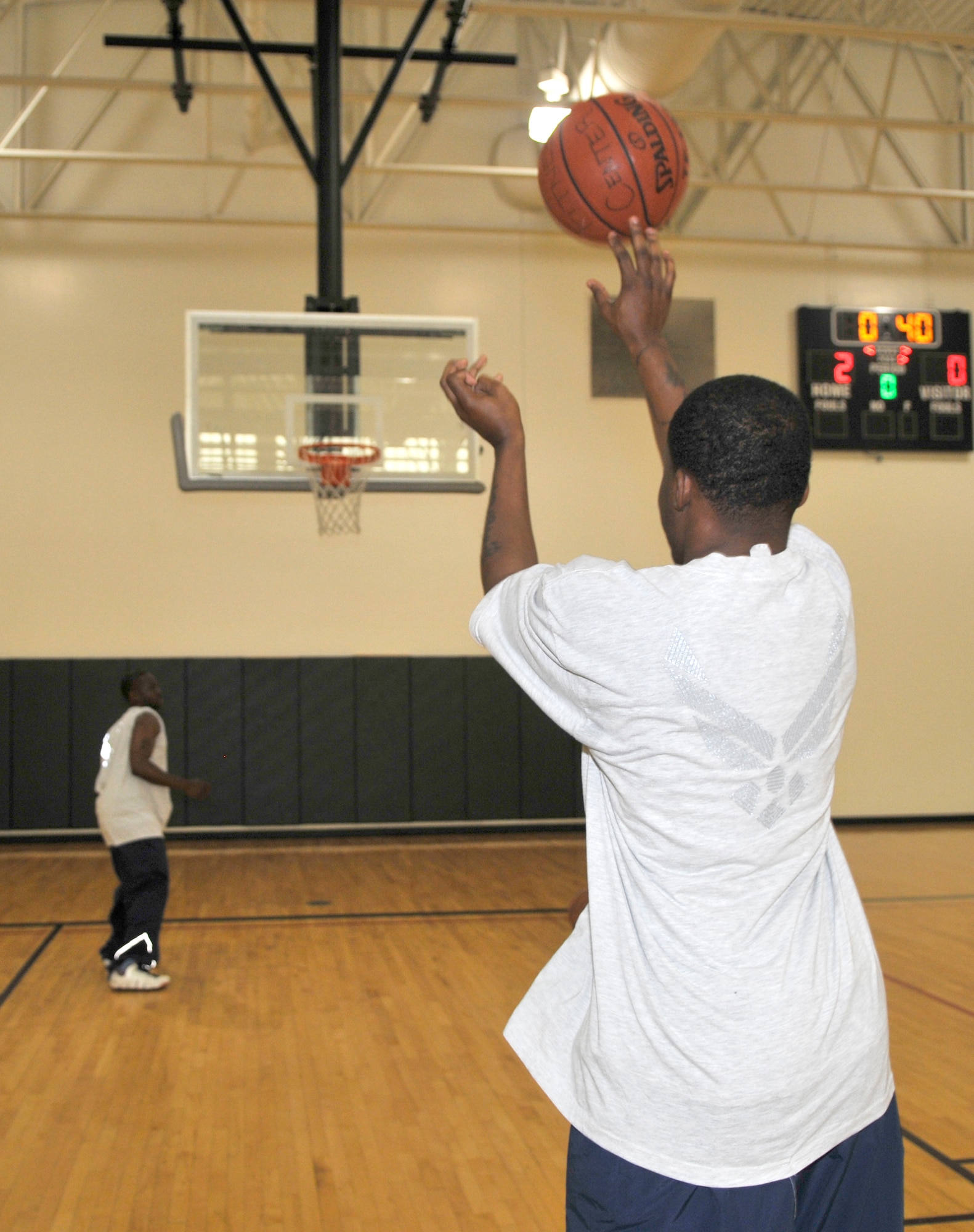 Staff Sgt. Marcus Banks, 305th Civil Engineer Squadron, shoots in the three-point basketball competition during Sports Day Sept. 24 at McGuire’s Fitness Center. The Warrior Run, which kicked off the day, brought out several Airmen to represent their squadrons. (U.S. Air Force photo/Kenn Mann)