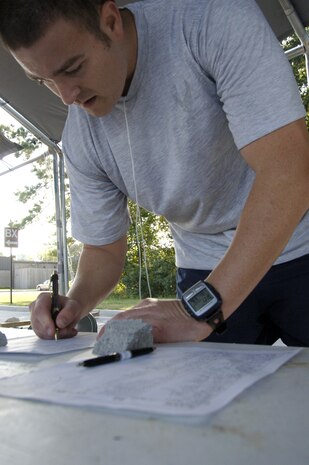 Staff Sgt. Steven Davenport records his number of completed laps after running in the early morning hours during the POW/MIA 24-hour vigil run at the base commissary Sept. 24. Sergeant Davenport is assigned to Detachment 5, 373rd Training Squadron. (U.S. Air Force photo/Airman 1st Class Timothy Taylor)
