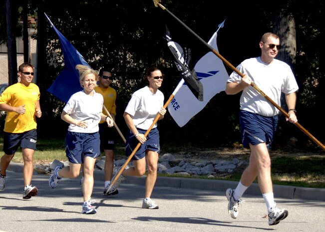 Col. John "Red" Millander kicks off the Charleston AFB POW/MIA 24-hour vigil run by leading participants with the POW/MIA flag at the base commissary Sept. 23. Airmen from Charleston AFB were joined by service members and cadets representing the other branches of the military throughout the 24-hour period to honor United States military members taken as prisoners of war and those who are still missing in action. Colonel Millander is the 437th Airlift Wing commander.  (U.S. Air Force photo/Airman 1st Class Timothy Taylor)