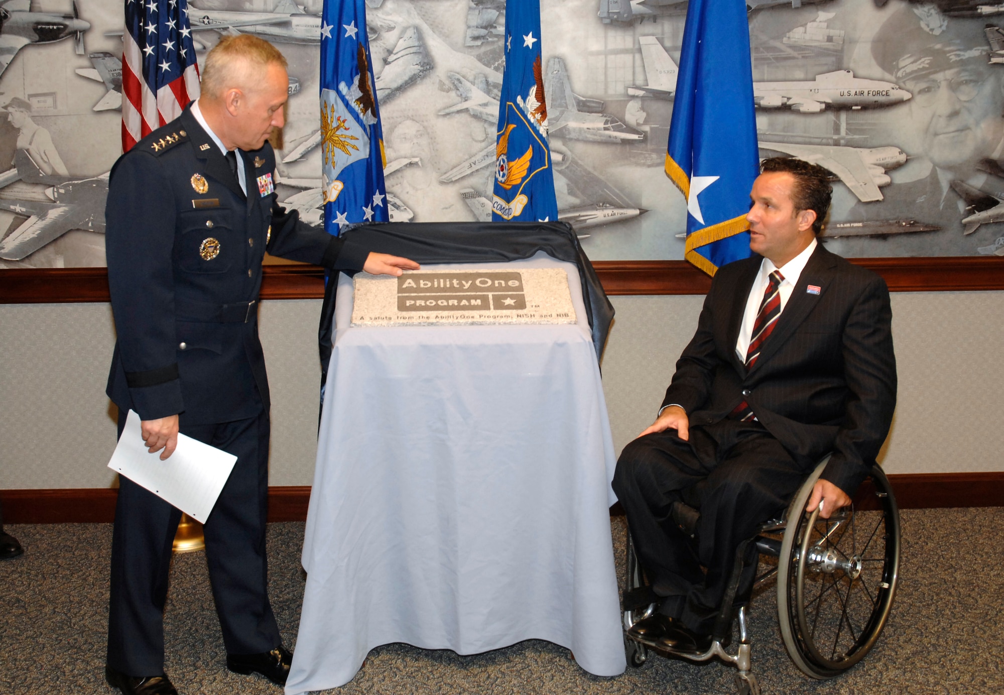 General Bruce Carlson, Air Force Materiel Command commander, and Andrew D. Houghton, chair, Committee for Purchase from People Who Are Blind or Severely Disabled, unveil the AbilityOne brick to be placed at the Wright "Flyer" Memorial at Wright-Patterson Air Force Base.  The Committee for Purchase From People Who Are Blind or Severely Disabled is an independent federal agency that administers the AbilityOne Program, creating job opportunities for persons who are blind or have other severe disabilities.  The Committee’s primary means of achieving its employment goal is through government purchases of supplies and services from nonprofit agencies employing such individuals. (U.S. Air Force photo)