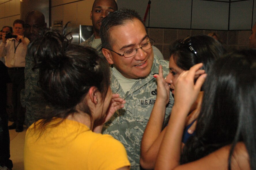 After six months in Afghanistan, member of the 433rd Civil Engineer Squadron returned home on Sept 22, 2008. Family and friends met them at San Antonio Airport with banners, cheers and even a few happy tears were shed during the reunion. The Alamo Wing engineers spent their deployment building and repairing structures at Bagram Airfield and several forward operating locations. They installed air conditioning units for Soldiers, brought older buildings up to U.S. Military construction codes and built brand new facilities. The group joined up with members of the Niagara Falls Air Force Reserve unit to create the first Prime BEEF, or Prime Base Emergency Engineer Force, team to operate in the country in almost two years.  (U.S. Air Force Photo/Master Sgt. Daniel Nathaniel)
