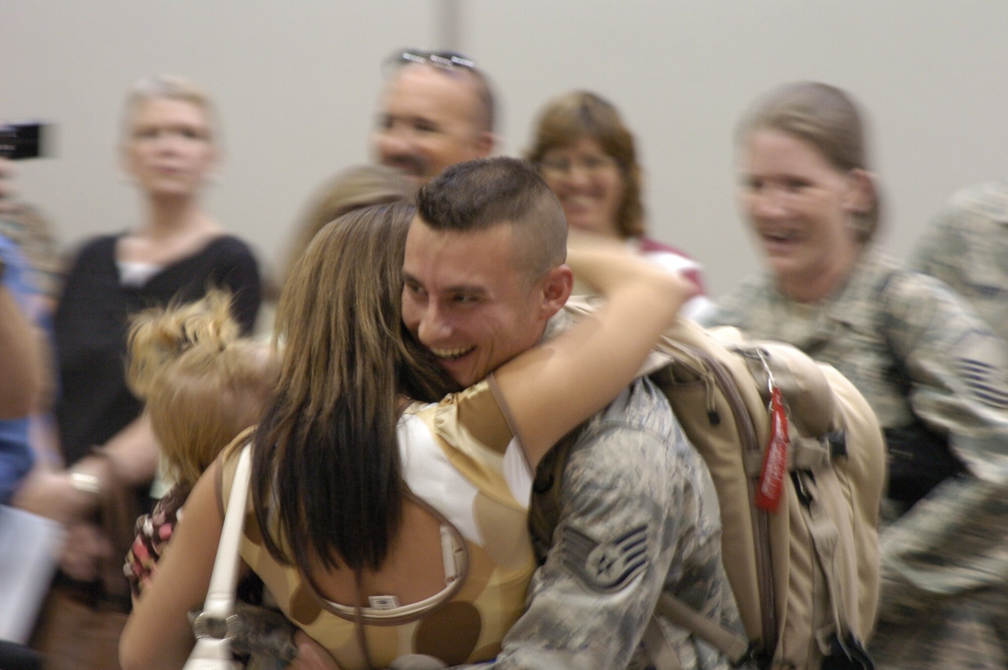 Staff Sgt. James Clark greets his wife at the Salt Lake International Airport on Sept. 11 as he and other members of the 75th Logistics Readiness Squadron return from a deployment. Members of their families, along with Col. Linda Medler, 75th Air Base Wing commander, were on hand to greet them.