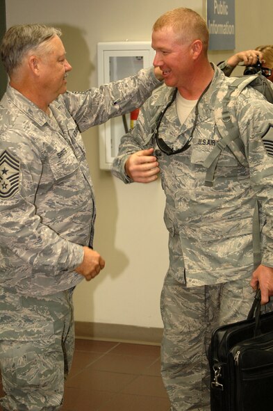After six months in Afghanistan, member of the 433rd Civil Engineer Squadron returned home on Sept 22, 2008. Family and friends met them at San Antonio Airport with banners, cheers and even a few happy tears were shed during the reunion. The Alamo Wing engineers spent their deployment building and repairing structures at Bagram Airfield and several forward operating locations. They installed air conditioning units for Soldiers, brought older buildings up to U.S. Military construction codes and built brand new facilities. The group joined up with members of the Niagara Falls Air Force Reserve unit to create the first Prime BEEF, or Prime Base Emergency Engineer Force, team to operate in the country in almost two years.  (U.S. Air Force Photo/Master Sgt. Daniel Nathaniel)