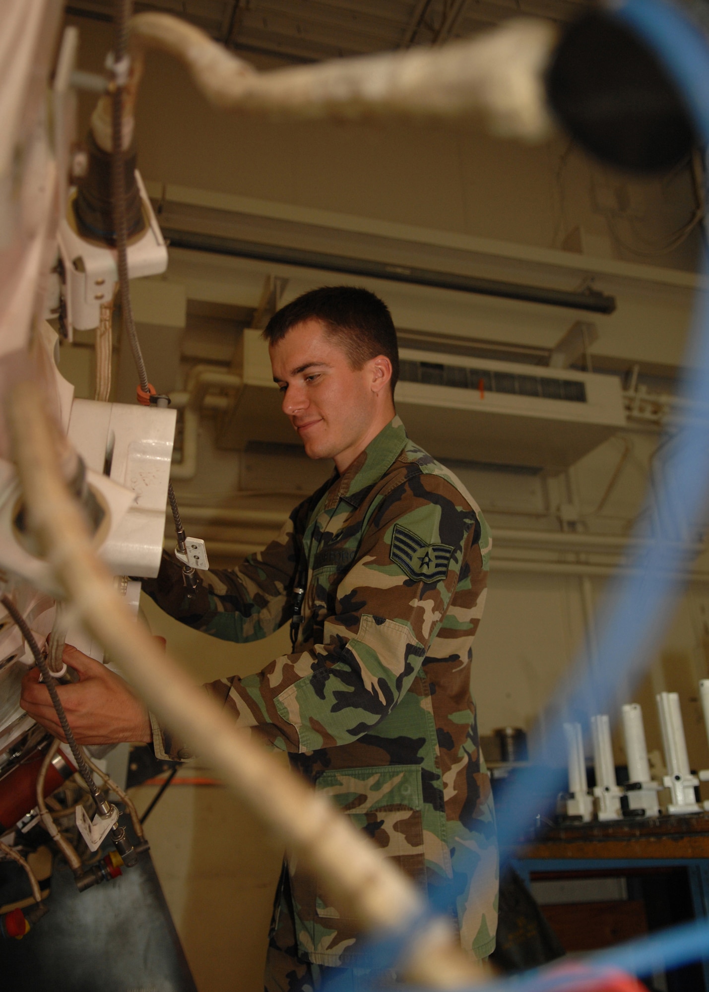 DYESS AIR FORCE BASE, Texas -- Staff Sergeant James Merrill, from the 7th Munitions Squadron, performs a 7-level inspection on a bomb rack here, June 4. After any maintenance is declared finished a 7-level must perform a thorough inspection to ensure everything works properly and it will be safe on its next flight. (U.S. Air Force photo/Airman 1st Class Jennifer Romig)