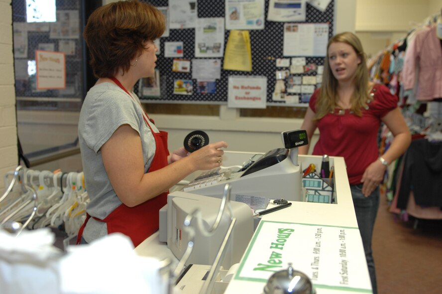 DYESS AIR FORCE BASE, Texas — Sharon Mikus provides costomer service to Summer Fox at the Dyess Thrift Shop Sept. 23. The Thrift Shop is run entirely by volunteers from the Officer’s Spouses Club. Last year alone, the Thrift Shop made $11,900, which the OSC used to provide 19 scholarships and other financial aid for base and community organizations including the Abilene Weatherization program and other non-profit agencies. Store hours are Tuesdays and Thursdays, 9 a.m. to 1:30 p.m., and the first Saturday of each month from 10 a.m. to 1 p.m.  Donations and consignments are accepted any time. Retirees, dependents, contractors and anyone who has access to the base is welcome to shop. (U.S. Air Force photo/Senior Airman Domonique Simmons)