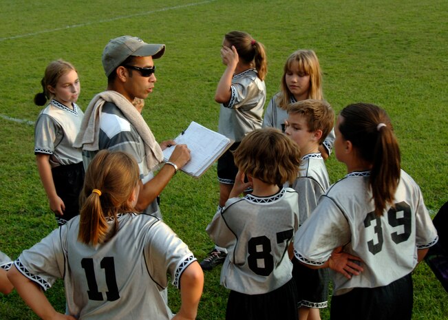 Coach Jose Gonzalez speaks to the Silver Bullets in a huddle at halftime to talk about positions and tactics before the game resumes at the base soccer field Sept. 22. The Hanahan Starz defeated the Silver Bullets 2-1. (U.S. Air Force photo/Airman 1st Class Timothy Taylor)