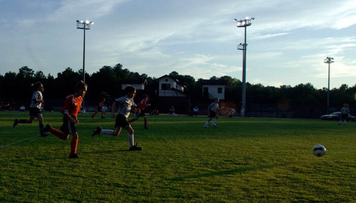 Players from both teams chase after a loose ball during a game at the base soccer field Sept. 22. The Hanahan Starz defeated the Silver Bullets 2-1. (U.S. Air Force photo/Airman 1st Class Timothy Taylor)