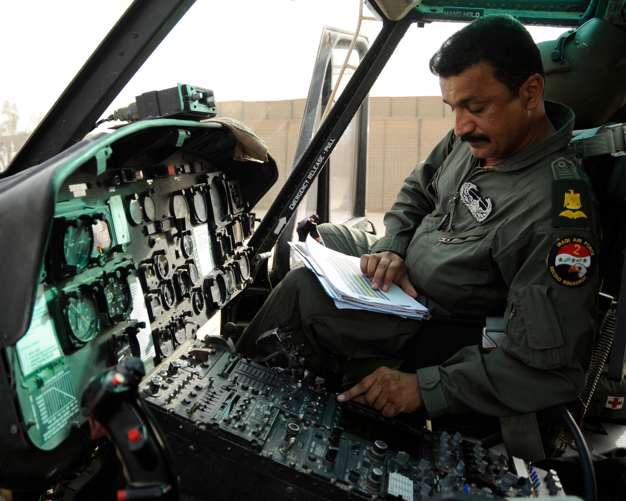Iraqi Air Force Maj. Rahman abd-Alkarem performs a preflight inspection on a UH-1H Huey for a gunnery training operation at Taji Air Base, Iraq, Sept. 12. Abd-Alkarem is a pilot with the Iraqi air force's 2nd Squadron. (U.S. Air Force photo/Staff Sgt. Paul Villanueva II)