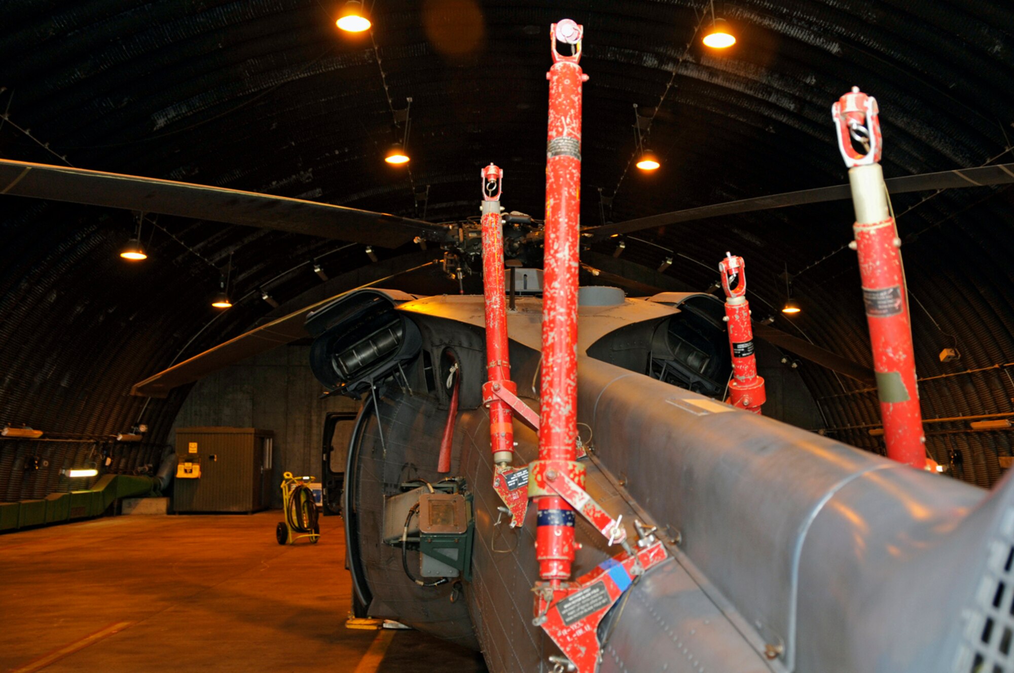 Tail boom adapters are installed and ready for the rotor blades to be swept back onto them Sept. 11 at RAF Lakenheath, England. The adapters will support the weight of the main rotor blades when they are folded back.  (U.S. Air Force photo by Airman 1st Class Perry Aston)