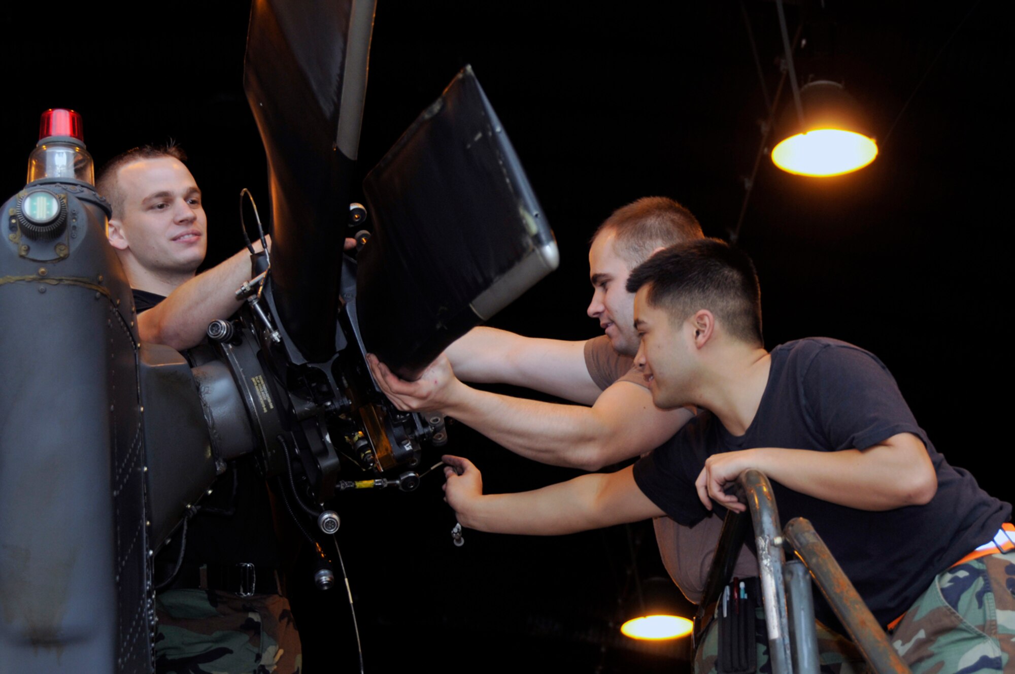 Staff Sgt. Matthew Reihle, Airman 1st Class Anthony Boone and Airman 1st Class John Gonzales, 48th Aircraft Maintenance Squadron HH-60G helicopter crew chiefs prepare the tail rotor for air shipment Sept. 11 at RAF Lakenheath, England. Folding the tail rotors and main rotors gives the clearance needed to fit the helicopter into a C-17 Globemaster III (U.S. Air Force photo by Airman 1st Class Perry Aston) 