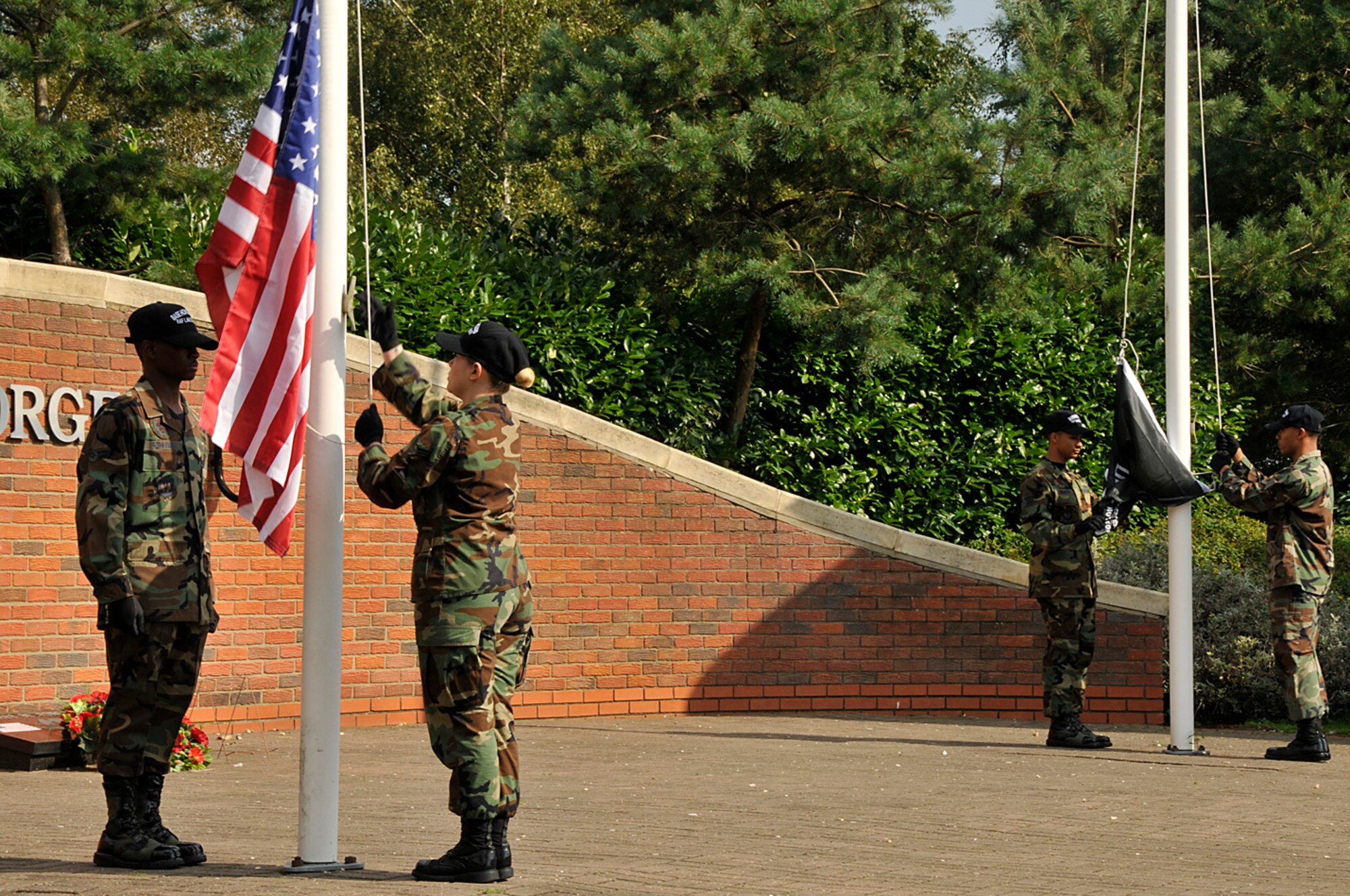 Airmen from the 48th Fighter Wing Honor Guard post the Colors and POW/MIA flag Sept. 18 at RAF Lakenheath, England. The ceremony was the start of a 24-hour memorial vigil to honor the missing. (U.S. Air Force photo by Airman 1st Class Perry Aston)
