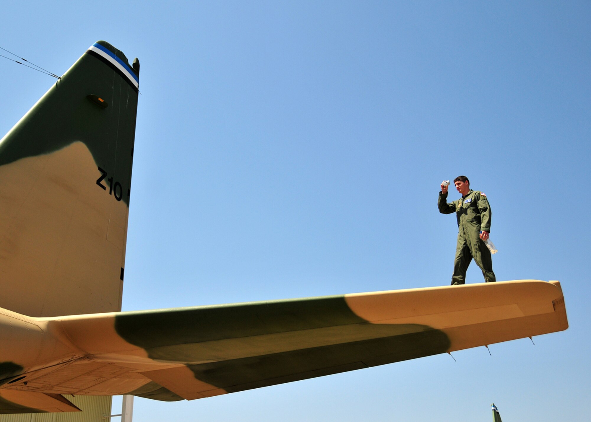 United States Air Force Staff Sgt. Joel Pomerene, 86th Aircraft Maintenance Squadron aircraft maintainer, takes some photos of the Botwanan C-130. (U.S. Air Force photo by Staff Sgt. Marcus Maier)(Released)