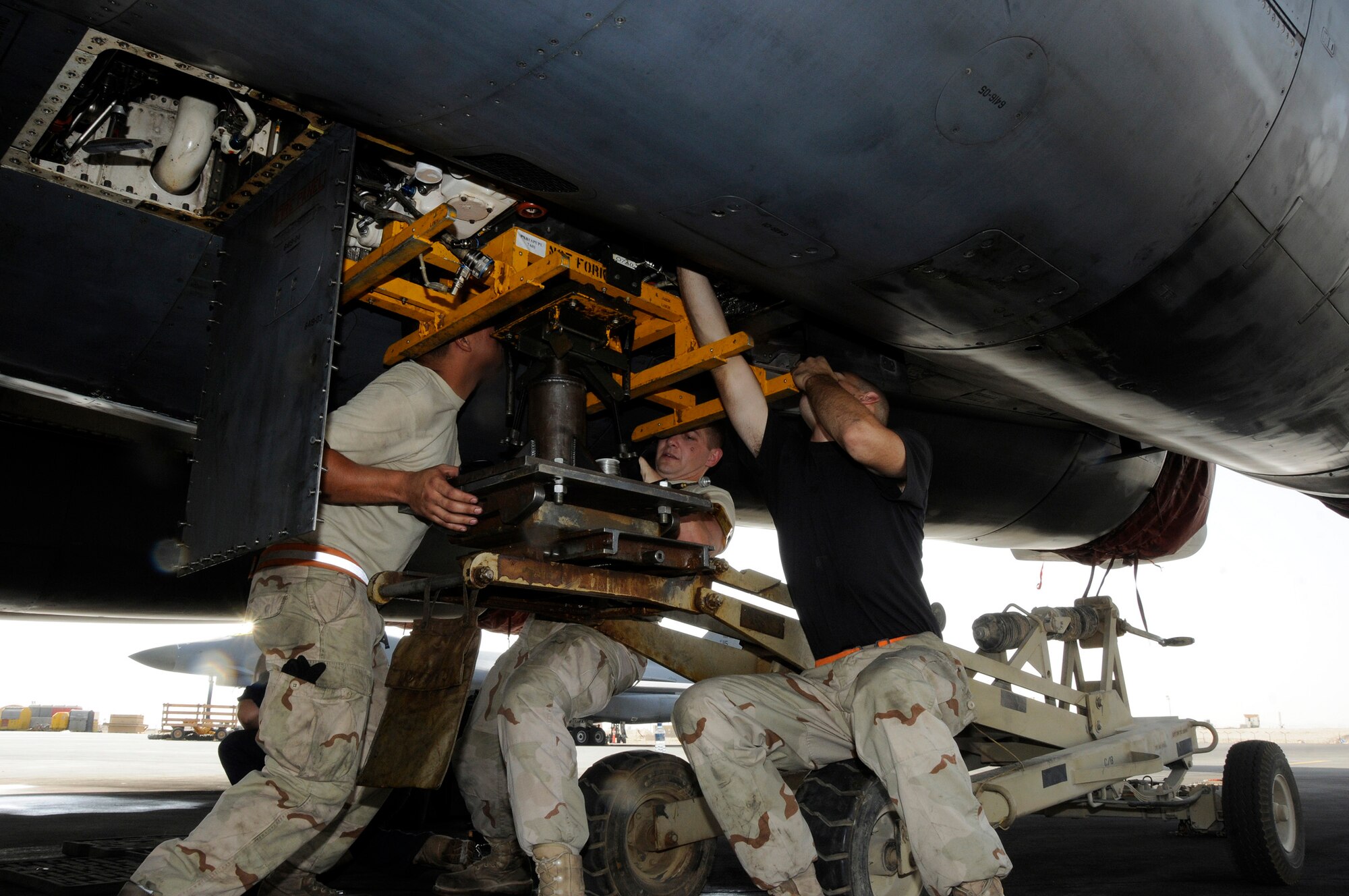 Airman 1st Class John Quintanila, Tech. Sgt. Matthew Boyer, and Staff Sgt. Andrew Grato, all assigned to the 379th Expeditionary Aircraft Maintenance Squadron, 34th Aircraft Maintenance Unit, position and lock an Auxiliary Power Unit into place Sept. 23, 2008.  The APU had to be replaced after an interior leak was discovered.  The work crew pulled the malfunctioning unit, prepared the replacement unit, and installed the new APU into a B-1 Lancer at this undisclosed air base in Southwest Asia.  Sergeant Grato is locking the unit into place as Airman Quintanila and Sergeant Boyer position the unit for installation.  The B-1, with long loiter times, massive payload, speed and precision weapons capabilities, provides valuable close air support to ground combatants engaged in Operations Iraqi and Enduring Freedom.  Sergeant Boyer hails from Saint Louis, Mo., Sgt. Grato from Saugus, Mass. and Airman Quintanila from Agat, Guam.  All are deployed from Ellsworth Air Force Base, S.D.  (U.S. Air Force photo by Tech. Sgt. Michael Boquette/Released)