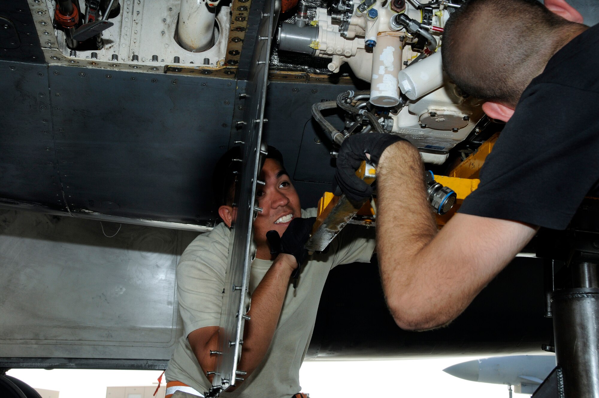 Airman 1st Class John Quintanila and Staff Sgt. Andrew Grato, 379th Expeditionary Aircraft Maintenance Squadron, 34th Aircraft Maintenance Unit, carefully watch edge clearances while positioning an Auxiliary Power Unit Sept. 23, 2008.  The APU had to be replaced after an interior leak was discovered.  The work crew pulled the malfunctioning unit, prepared the replacement unit, and installed the new APU into a B-1 Lancer at an undisclosed air base in Southwest Asia.   The B-1, with long loiter times, massive payload, speed and precision weapons capabilities provides valuable close air support to ground combatants engaged in Operations Iraqi and Enduring Freedom.  Sergeant Grato hails from Saugus, Mass., and Airman Quintanila is a native of Agat, Guam; both are deployed from Ellsworth Air Force Base, S.D.  (U.S. Air Force photo by Tech. Sgt. Michael Boquette/Released)