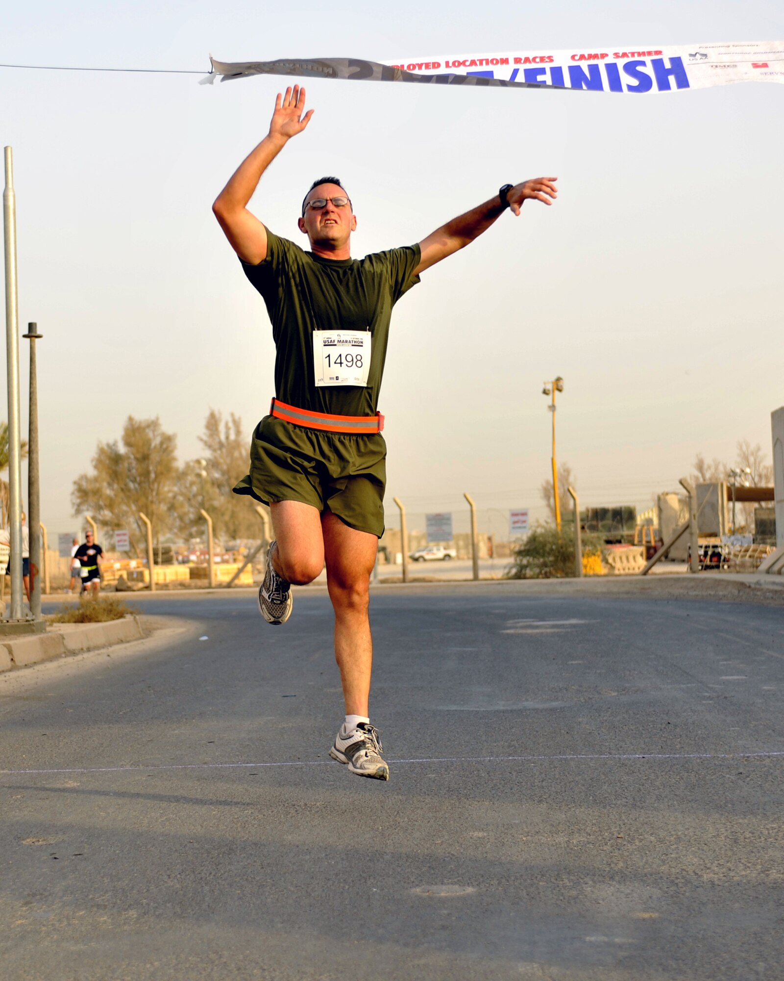 9/20/2008 ? SATHER AIR BASE, Iraq ? John Mazzarella crosses the finish line at the 10-K run hosted in Baghdad as part of the 12th Annual Air Force Marathon. Mazzarella finished the run with a time of 43:14. More than 300 Airmen, Soldiers, Marines, Sailors, Defense Department civilians, contractors and coalition military members came out to participate in the run on dirt roads along the flightline west of Baghdad International Airport. The 26.2-mile Air Force Marathon, hosted at Wright-Patterson Air Force Base, Ohio, kicked off with a fly-over by a formation of an F-16 Fighting Falcon, F-15 Strike Eagle and F-22 Raptor. The Baghdad runners also had a flyover of sorts, as a C-17 Globemaster III and C-130 Hercules, as well as HH-60 Blackhawk helicopters all took off from Sather AB during the run in support airlift missions in and around the Operation Iraqi Freedom theater of operations.   (U.S. Air Force photo by Master Sgt. Brian Davidson)